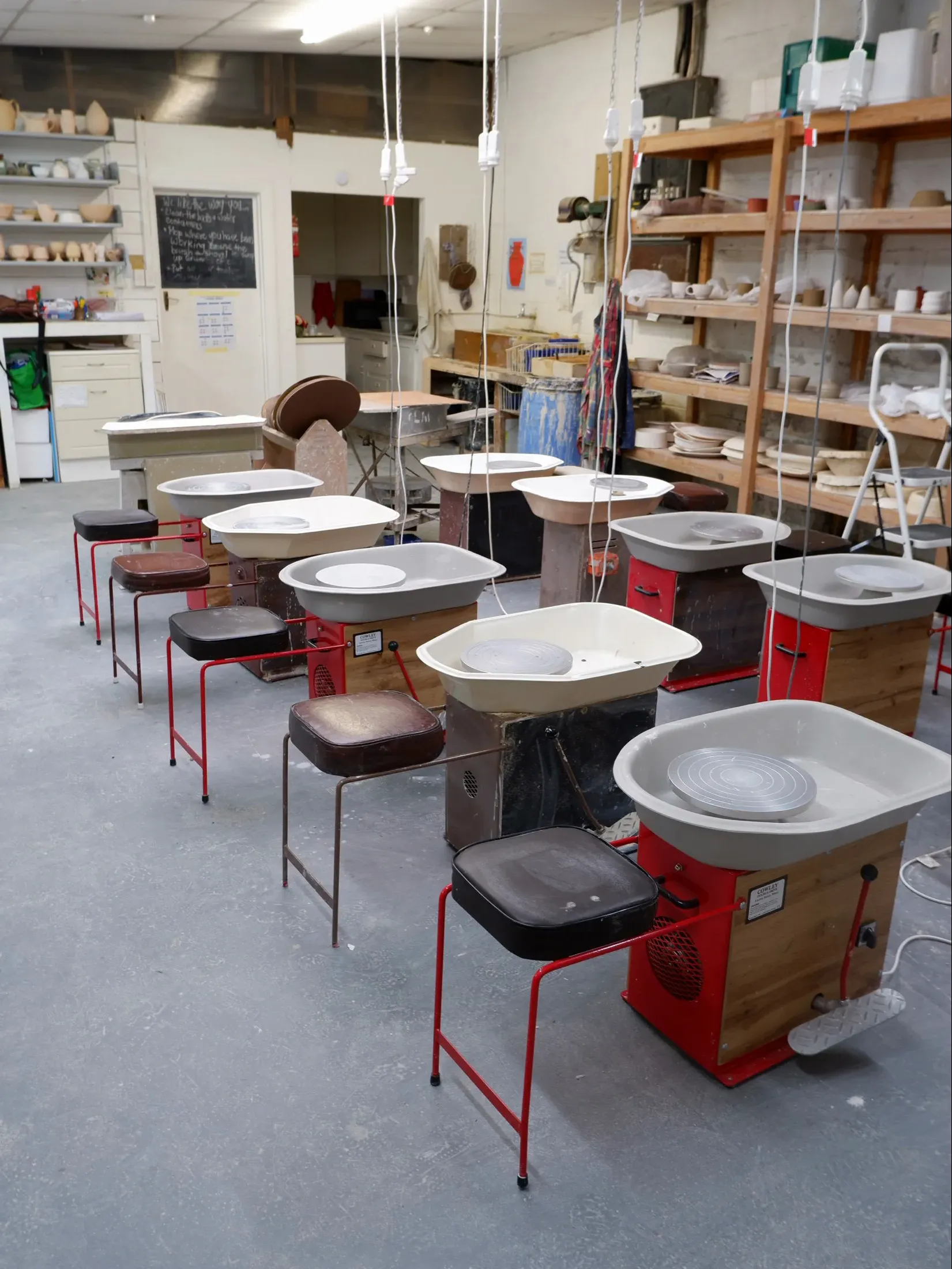 Warm pottery studio shelves with handmade ceramic work